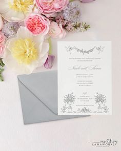 the wedding stationery is surrounded by pink and yellow flowers, including peonies