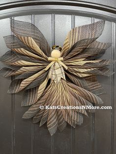 a metal door with a decorative wreath on the front and side of it that has leaves attached to it