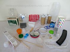 an assortment of crafting supplies are displayed on a table with paper cups and other items