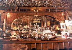 an old fashioned bar with lots of bottles