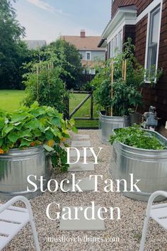 an outdoor garden with metal tubs and plants