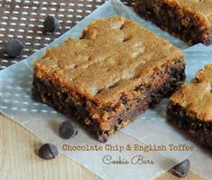 three chocolate chip and english toffee brownies on a piece of parchment paper