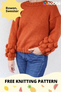 a woman wearing an orange sweater and jeans with her hands on her hips, while she is