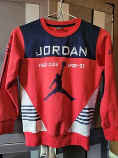 Vintage Michael Jordan youth crewneck sweatshirt Graphic Print Long Sleeve Sweatshirt For Sports Season, Long Sleeve Graphic Print Sweats For Sports Season, Long Sleeve Sweats With Graphic Print In Sportswear Style, Graphic Print Long Sleeve Sweats For Sportswear, Graphic Print Long Sleeve Sweats In Sportswear Style, Red Hoodie With Logo Print And Crew Neck, Red Crew Neck Hoodie With Logo Print, Sports Season Letter Print Long Sleeve Sweater, Long Sleeve Letter Print Sweater For Sports Season