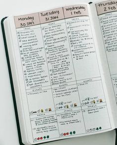 an open planner book sitting on top of a table