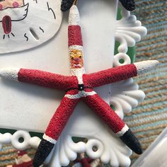 an ornament made to look like a red and white starfish on a table