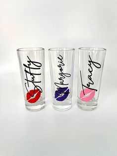 three shot glasses with lipstick painted on the bottom and one has writing that says, i love you