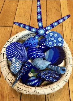 a basket filled with blue items on top of a wooden floor