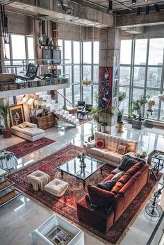 a living room filled with lots of furniture and large windows overlooking the cityscape