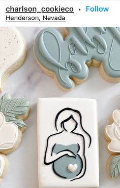 some cookies are laying next to each other on a white table with blue and green decorations