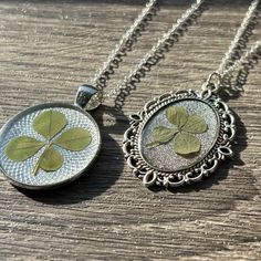 These elegant lucky charmed necklaces will for sure give you the best of luck :) Not only are these necklaces an elegant wear, but they're also as lucky as can be making a beautifully unique look for any occasion!  Genuine and handpicked from Mercersburg, Pennsylvania. Painted a natural green, your fern/four leaf clover will maintain its natural vibrant green color and texture lasting a lifetime. Gently placed inside for the best protection and look. Each charm has a silver/bronze chain.  Pendant Tray Material: Metal Alloy Pendant Tray Color: Silver or Bronze Necklace/Chain Length: 20inch The silver/bronze pendant tray bezels beautifully surrounds the piece inside, measuring L/W - 1 1/2 x 1 inches. The four leaf/fern is preserved between silver/bronze metal alloy and high quality epoxy res Silver Necklaces With Flower Charm For Good Luck, Silver Oval Necklaces With Charms, Silver Necklace With Flower Charm For Good Luck, Oval Charm Necklaces As Gift, Oval Charm Necklaces For Gifts, Elegant Nickel Free Charm Necklace With Oval Pendant, Elegant Nickel Free Oval Pendant Charm Necklaces, Elegant Nickel-free Oval Pendant Charm Necklace, Oval Charms Necklace For Gift