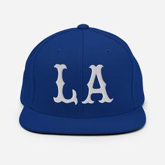 the los angeles dodgers baseball cap is shown in blue with white embroidered letters on it