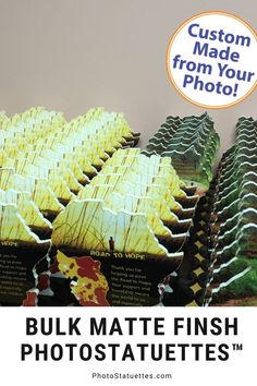 a bunch of cakes sitting on top of each other in front of a sign that says, custom made from your photo