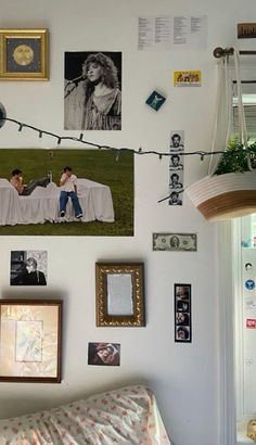 there are many pictures on the wall with string lights