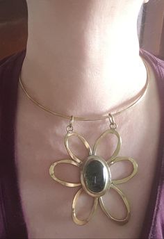 As far as Rafael jewellery goes, this is one of the best ones I have seen. It is brass and green glass. The pendant is 3 inches by 3 inches and the the ring is 4 3/8 inches wide. The flower is marked Rafael Canada at the back. C. 1970 and in nice condition and very showy! Follow me on instagram@jettesjewels. Vintage Brass Flower Jewelry, Vintage Hand Forged Brass Jewelry, Vintage Green Jewelry With Large Pendant, Green Metal Jewelry With Large Pendant, Unique Brass Flower-shaped Jewelry, Flower-shaped Bronze Brass Jewelry, Bronze Brass Flower Jewelry, Handmade Brass Modernist Jewelry, Bronze Brass Flower-shaped Jewelry