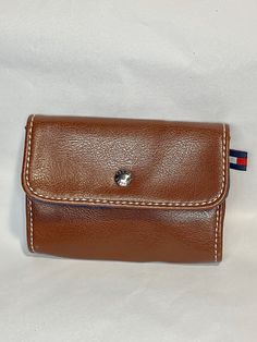 a brown leather wallet with a blue, red and white stripe around it