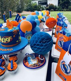 a table topped with lots of blue and orange decorations