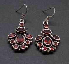 Beautiful Vintage Art Deco Stamep 925 Sterling Silver & Red Garnet Cluster Drop Earrings pre/owned condition measures 1 5/8" x 3/4" width. Red Dangle Earrings Stamped 925, Traditional Oval Red Earrings, Ornate Red Earrings For Formal Occasions, Traditional Red Oval Earrings, Ornate Red Sterling Silver Earrings, Hallmarked Oval Red Earrings, Red Teardrop Earrings Hallmarked, Red Garnet Round Earrings, Vintage Red Sterling Silver Earrings