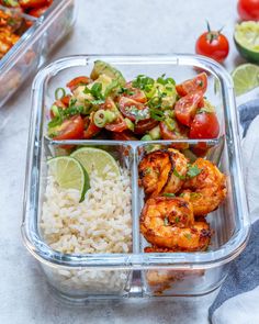 a plastic container filled with rice, shrimp and veggies on top of it