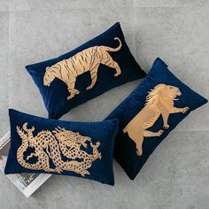 two blue and gold pillows with lions on them