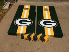 two green bay packers cornhole game boards laying on the ground next to each other