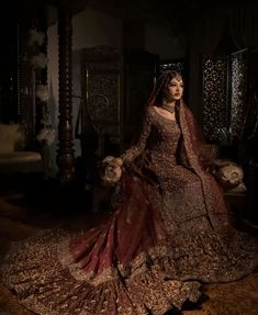 a woman in a red and gold wedding dress