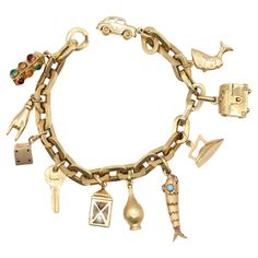 18K Gold Chain Bracelet with a Full Collection of Charms. While it’s visually massive and weighing 42 gr is not light, the chainrings are actually hollow and sit perfectly on the wrist without making it too heavy to wear. A full collection of charms for all the possibilities of life: Traffic light Hand gesture Lucky dice Key Lantern Bottle Goldfish Iron Treasure chest Egyptian Goddes Car All the charms are perfectly made and finished. A true future classic, its value will be sure to rise as time Vintage Gold Charm Bracelet Luxury, Luxury Gold Charm Bracelet With Solid Link Construction, Luxury Charm Bracelet With Dangling Charms, Luxury Yellow Gold Fine Jewelry Charm Bracelet, Cheap Gold Bracelets With Vintage Charm, Luxury Yellow Gold Collectible Charm Bracelet, Luxury Gold Plated Chain Charm Bracelet, Luxury Yellow Gold Chain Charm Bracelet, Luxury Vintage Engraved Charm Bracelet