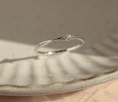 a diamond ring sitting on top of a white plate