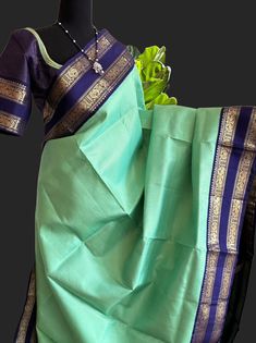 Beautiful pastel green with dark blue border heavy pallu (wedding collection)  pure zari kanjivaram silk saree with prestitched blouse vaairaoosi fine gold zari lines  Expertly crafted with pure vaira oosi handwoven silk, this traditional kanjivaram saree boasts a stunning zari lines pattern. Each saree comes with a prestitched blouse and pett border, making it easy to wear for any occasion. Elevate your style with this pure silk saree, available online now.Gold zari lines pure kanjivaram saree online usa. hand embroidered blouse -36 goes up to 42 inches   Ships from Texas usa - immediate shipping    DETAILS AND CARE Color : pastel green  kanjivaram silk saree  Weight : 600 - 800 grams Length : 5.5 m saree + 0.7 m blouse  Width : 48 Inches Fabric : Pure Kanjivaram Pattu Plain Silk Craft De Elegant Blue Saree With Border, Transitional Green Paithani Silk Saree, Blue Wedding Saree With Border, Green Tissue Silk Lehenga With Zari Weaving, Green Raw Silk Traditional Wear For Puja, Green Handloom Traditional Wear For Wedding, Traditional Wear With Tissue Silk Border, Transitional Green Lehenga For Puja, Transitional Green Tussar Silk Traditional Wear