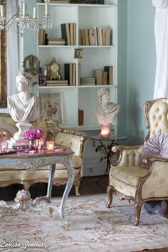 a living room filled with furniture and a chandelier