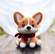 a small crocheted fox sitting on top of a wooden table