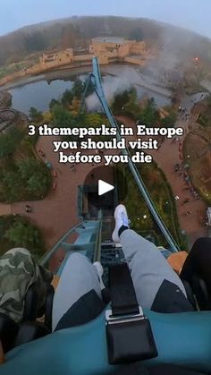 the view from inside an amusement park looking down at people riding on roller coasters