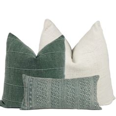 two green and white pillows sitting next to each other