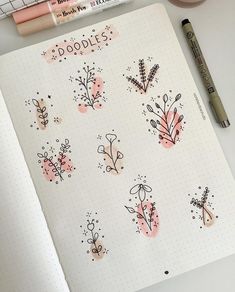 an open notebook with doodles on it and some markers next to the pages that have flowers in them