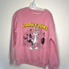 Pink Looney Tunes Medium New Without Tags Oversized Cartoon Print Crew Neck Top, Graphic Print Crew Neck Sweater For Loungewear, Loungewear Graphic Print Crew Neck Sweater, Relaxed Fit Crew Neck Sweater With Cartoon Print, Retro Long Sleeve Top With Funny Print, Winter Cartoon Print Tops For Loungewear, Retro Long Sleeve Sweatshirt With Cartoon Print, Retro Winter Tops With Cartoon Print, Pink Crew Neck Top With Screen Print