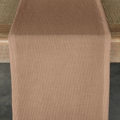 a close up view of the top of a table with a brown cloth on it