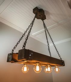 a chandelier hanging from the ceiling with five lights on it and four bulbs