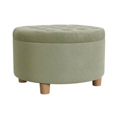 a round ottoman with wooden legs and a light green upholstered cushion on top