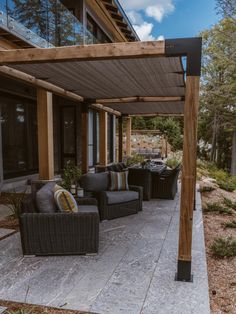 an outdoor covered patio with chairs and tables