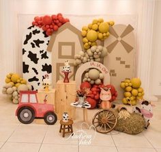 an image of a birthday party setting with farm animals and balloons on the wall behind it