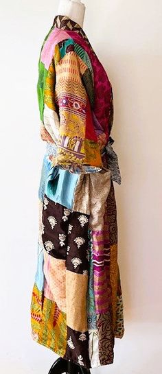 This stand-out kimono is full kaleidoscope of bright colors like a blooming spring garden. Constructed with high quality, ultra luxe sari silk, handmade. Designed as a traditional long kimono with an extra wide front band and self tie belt. Special detailing is noticable throughout the garment, double width hem panel, etc. Feels wonderful against your skin. Worn open, breezy flowing statement. The bright color pallet works well with most skin tones. True statement, one-of-a-kind designer piece. Bohemian Multicolor Silk Kimono, Multicolor Silk Kimono With Kimono Sleeves, Multicolor Patchwork Kimono For Festivals, Multicolor Bohemian Kimono For Festivals, Long Multicolor Silk Kimono, Multicolor Long Silk Kimono, Handmade Multicolor Spring Kimono, Long Multicolor Kimono For Festivals, Bohemian Silk Kimono For Festive Occasions