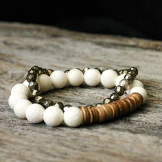 "Coral Coconut Stacking Bracelet / Pure White Toffee Caramel Brown Heishi / Earth Tones Neutral Fashion Jewelry Staple Beadwork Bracelet Gorgeous pure white coral is perfectly paired with coconut wood in this wonderful neutral stacking bracelet. It goes so well with so many pieces in my shop. If you would like suggestions, please don't hesitate to ask! It is incredibly lightweight and comfortable. Other bracelets shown in images: Turquoise Acai Seed: http://www.etsy.com/listing/163369296/turquoi Bohemian Cream Adjustable Stretch Bracelet, Adjustable Double Strand Beaded Bracelets Hand-strung, Adjustable Double Strand Hand-strung Beaded Bracelets, Double Strand White Beaded Bracelets, White Beaded Double Strand Bracelet, Adjustable Cream Bohemian Beads, Adjustable Double Strand Spiritual Beaded Bracelets, Pyrite Bracelet, Fools Gold