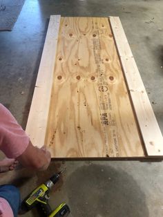 a person is working on a piece of plywood that has been cut in half