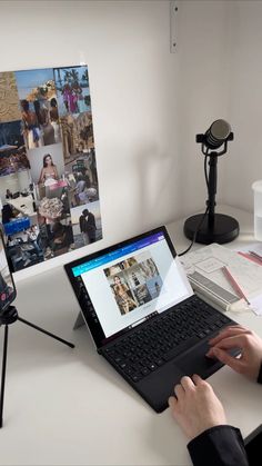 a person sitting at a desk using a laptop computer