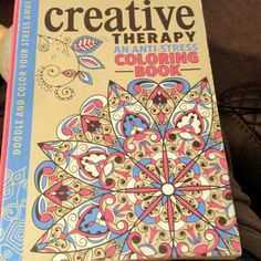 an adult coloring book sitting on top of a person's lap, with the title creative therapy