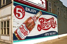 an old building painted with advertisements on the side