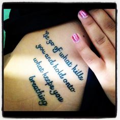 a woman's tattoo with words written on it