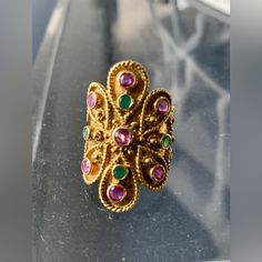 Ruby & Emerald 18k Yellow Gold Floral Long Finger Ring Marking: 750 A.16 Gemstone: 1.50ct Rubies And Emerald Measurement: Top: 7/8" Across 1 5/16" Long Ring Size: 8 Weight: 12 Grams Pre Owned In Excellent Condition. This Gorgeous Ring Is Crafted From 18k Yellow Gold Featuring A Fancy Fine Wire Design Fashioned Into A Floral Design With Scallop Shape Edge Around The Sides And Two Longer End. Between The Rope Patterns Are Round Cut Bezel Set 7 Rubies And 4 Emerald Gemstones, The Ring Has A Long An Elegant Gold Emerald Toe Ring, Gold Multi-stone Round Emerald Ring, Gold Multi-stone Emerald Ring, Antique Gold Multi-stone Emerald Ring, Antique Gold Emerald Ring With Multi-stone, Heirloom Multi-stone Emerald Ring In Gold, Elegant Multi-stone Emerald Ring In Gold, Elegant Gold Multi-stone Emerald Ring, Elegant 22k Gold Emerald Ring