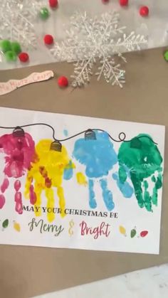 handprinted christmas cards are displayed on a table