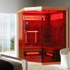 a red sauna is in the corner of a room